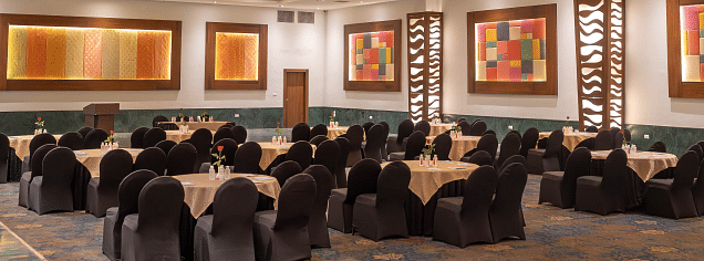 A banquet hall with tables and chairs set for an event. - Bamboo Saa Resort & Spa, Udaipur.
