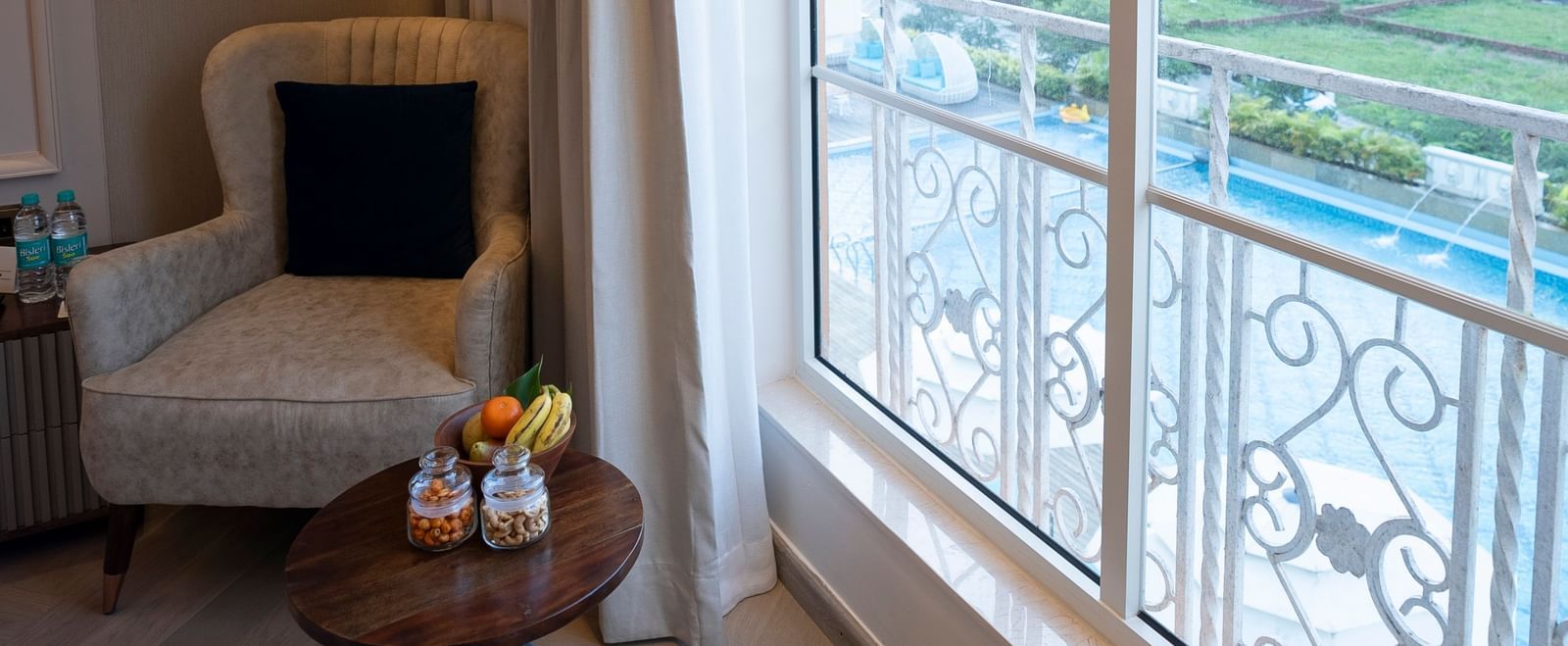Cosy seating area with natural light and pool view at Miros Hotels.
