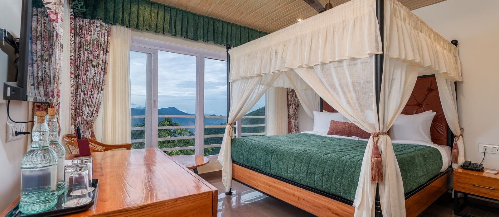 A spacious bed with ample lighting, complemented by wooden furniture