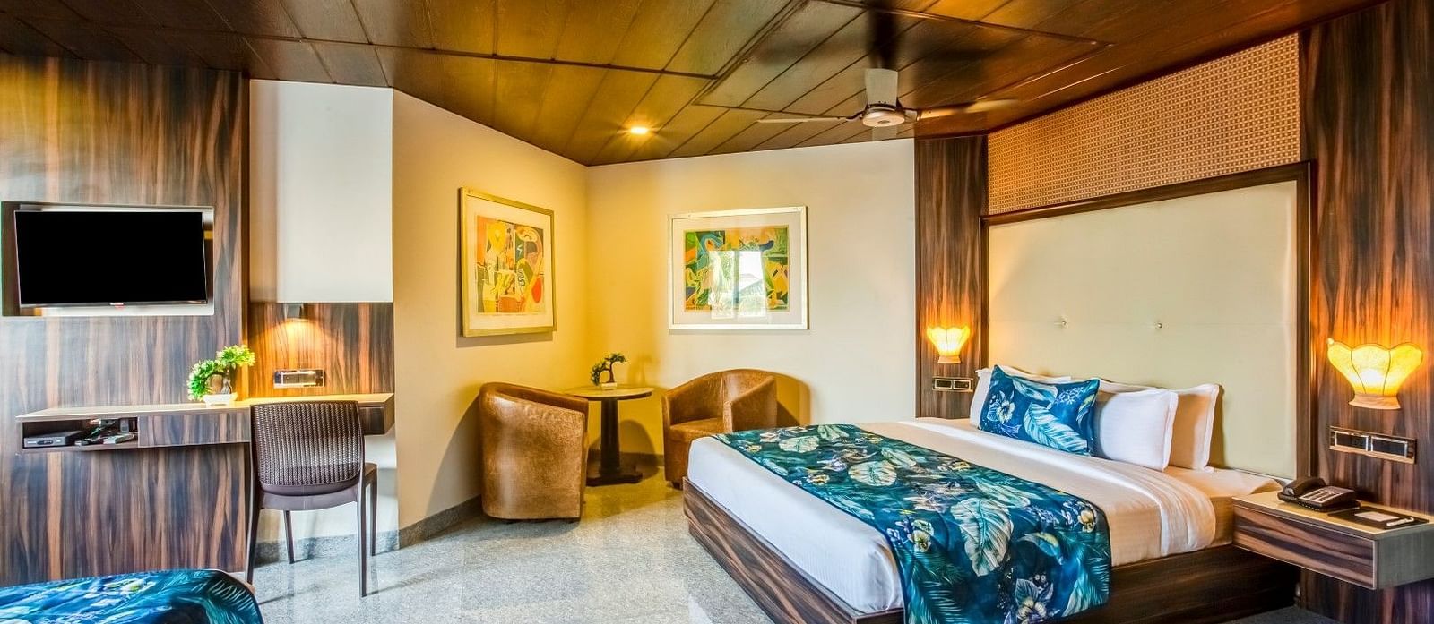  Generously sized bed flanked by two cushioned sofas with a sturdy table placed between them