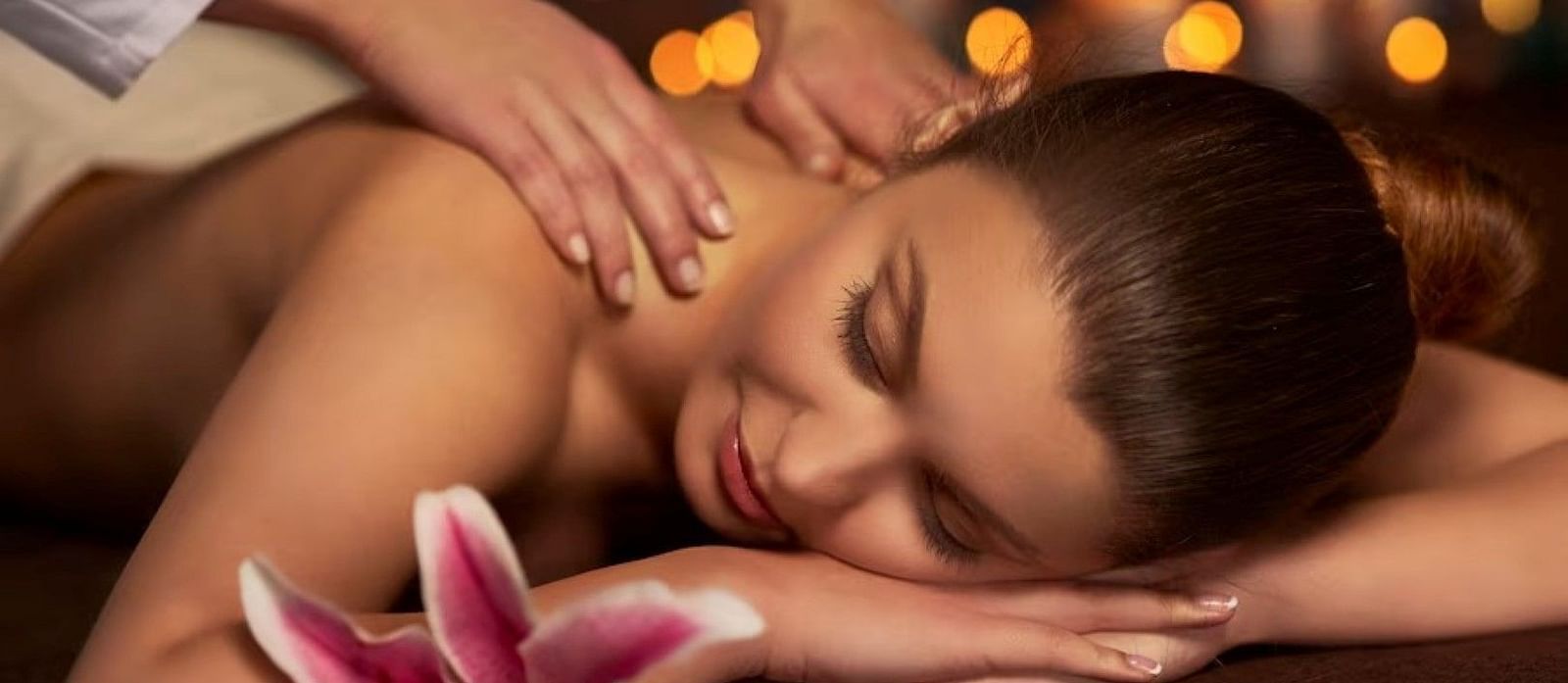 A woman reclining on the spa bed for a massage
