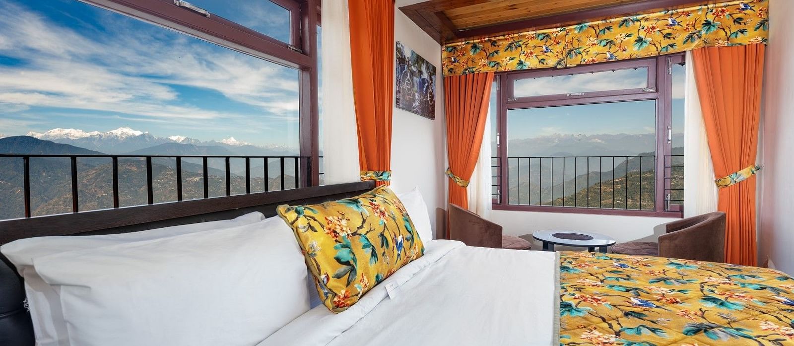 Image of a room with bed and two large windows with view of the mountians at Summit Sherpa Mountain Hotel & Spa, Kalimpong