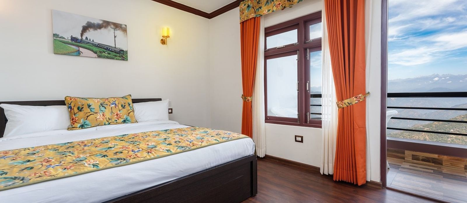 Image of a room with bed and attached balcony at Summit Sherpa Mountain Hotel & Spa, Kalimpong