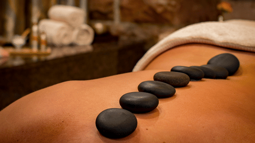 A person undergoing hot stone massage