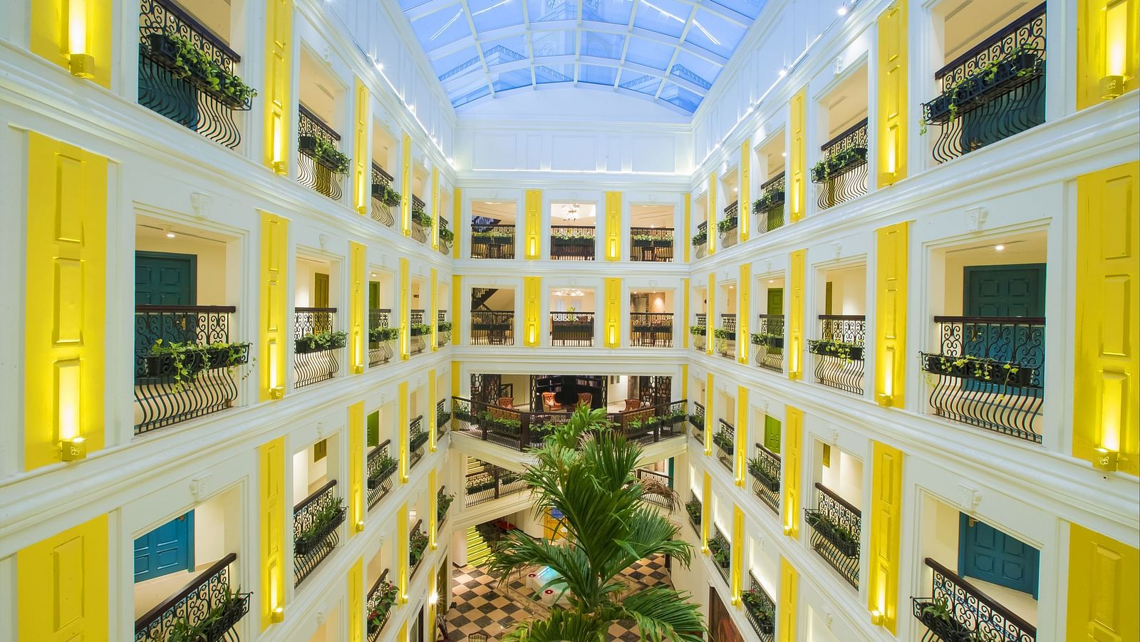 Lobby area with chandelier lighting and furniture arranged neatly