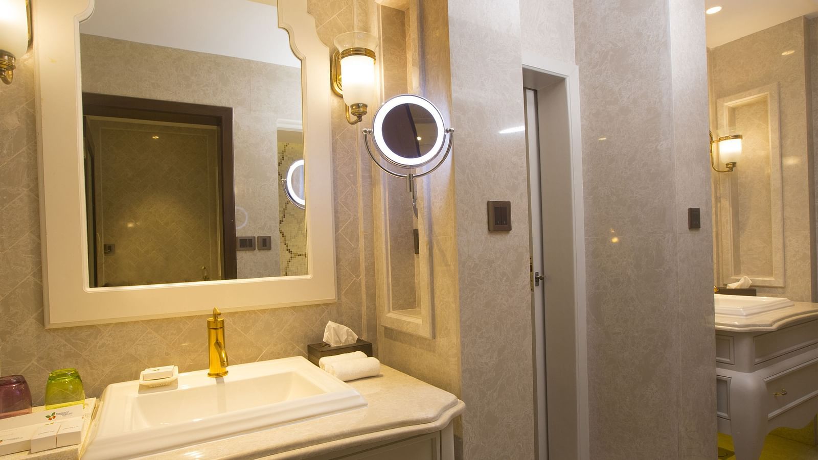 Bathroom with a mirror above the washbasin and separate lighting set for it
