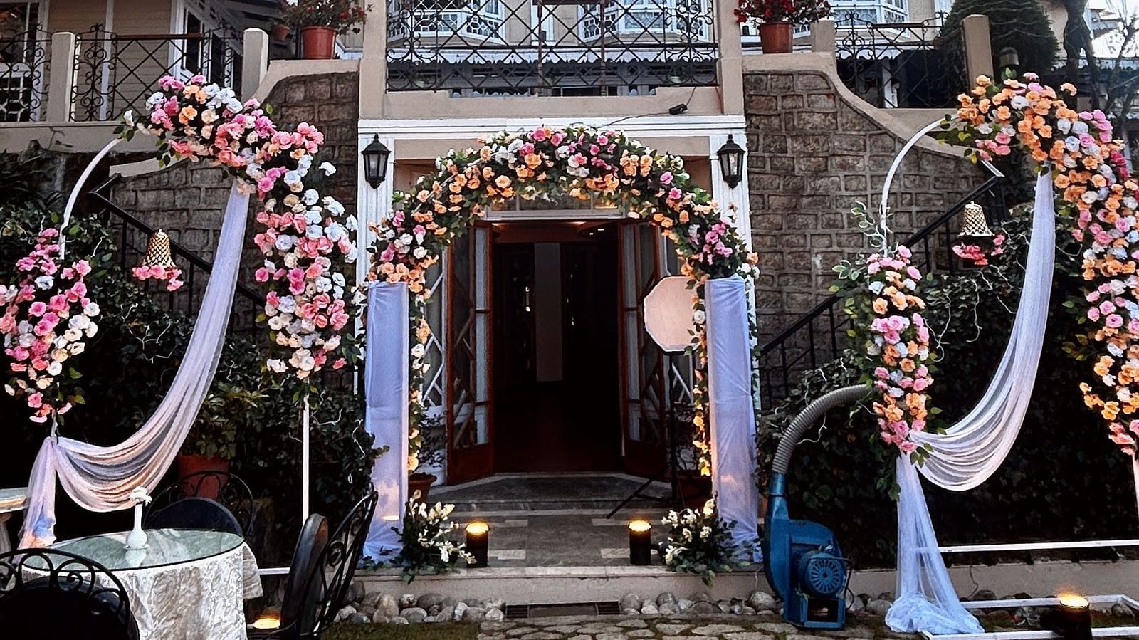 Wedding celebrations at Cedar Inn, Darjeeling, highlighting outdoor seating and traditional decor in front of the hotel façade.