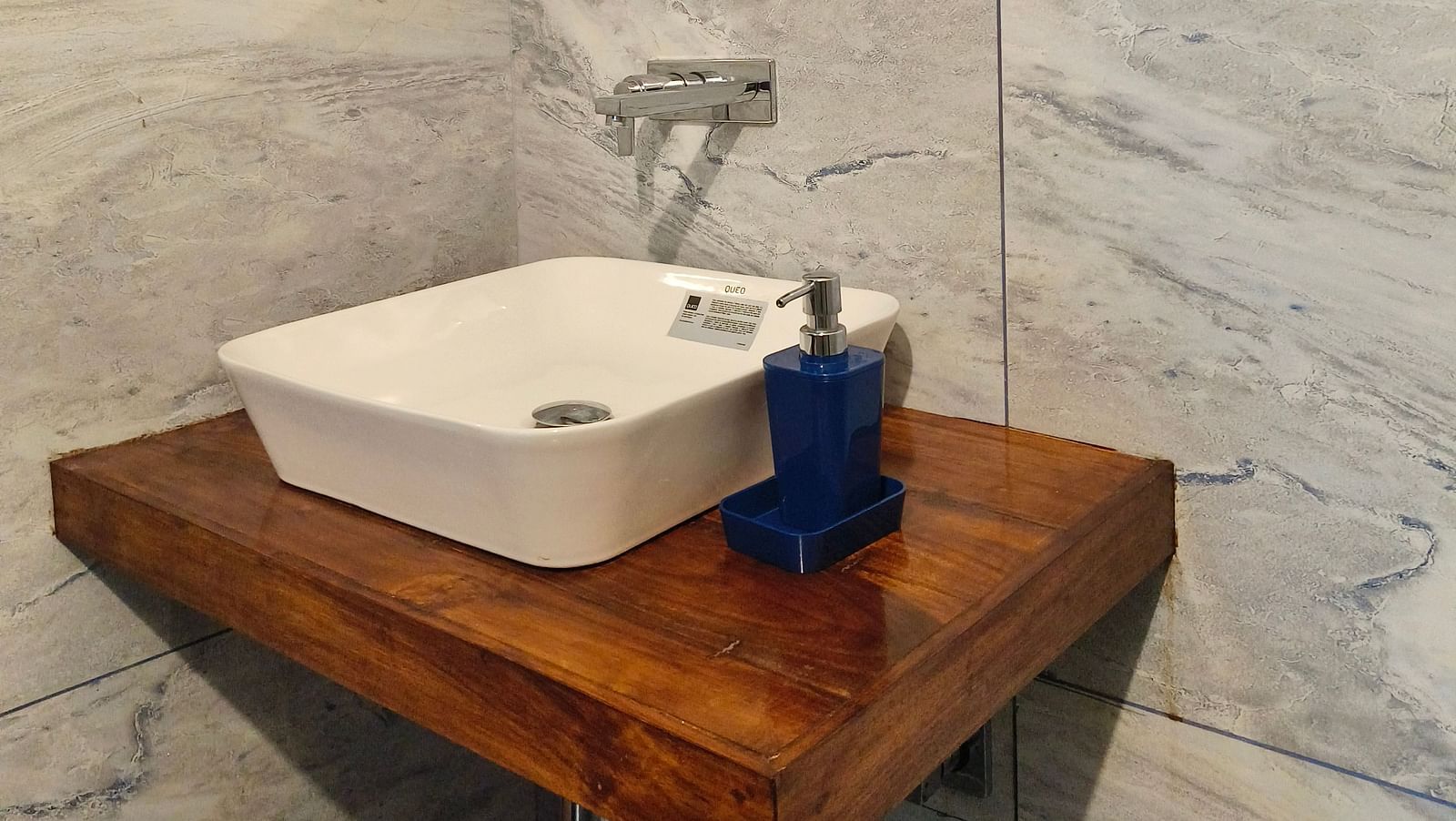 A sink and a mirror in the washroom at 103 room at Ananda Holiday Home, Wayanad 6