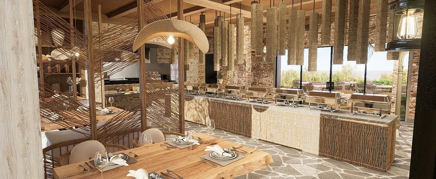 Diagonal view of the restaurant with neatly set tables and chairs, featuring a central table with a buffet setup at The Evren, Vagator.