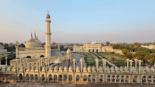 A historic building with minaret, arches, and courtyard seen from above.