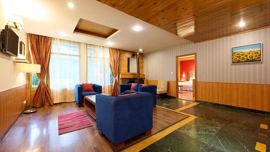 Renest Manali - interior view of the living room featuring blue coloured sofas 