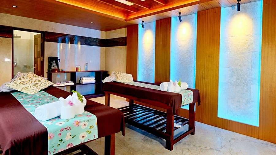 Spa room with ambient lighting and wooden interiors at Vythiri Resort, Wayanad