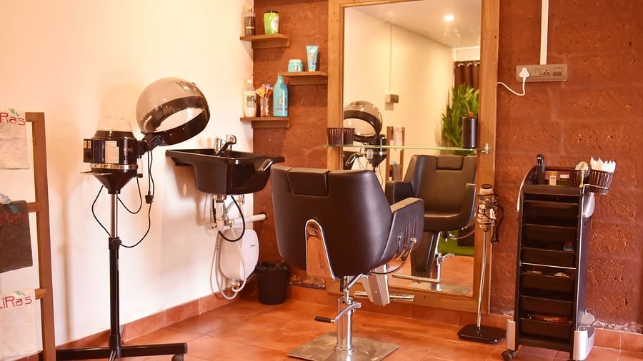 This image shows a hair salon area at Forest Escape, with styling chairs, mirrors, and professional equipment.
