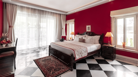 Dileep Kothi, our luxury hotel in Jaipur has Executive Heritage Suites with a double bed, side tables with night lamps, French windows and checker-ed tiles.