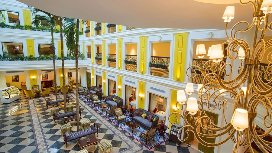 Lobby area with chandelier lighting and furniture arranged neatly