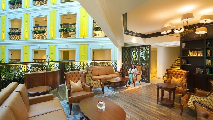 Lobby area with chandelier lighting and neatly arranged furniture