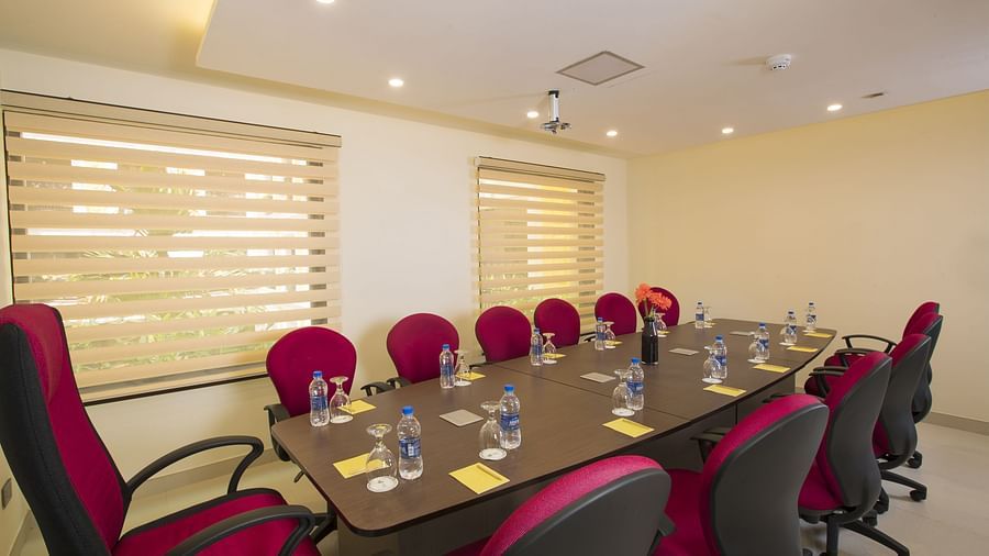 Chairs and table arranged in a boardroom setup, ready for the meeting
