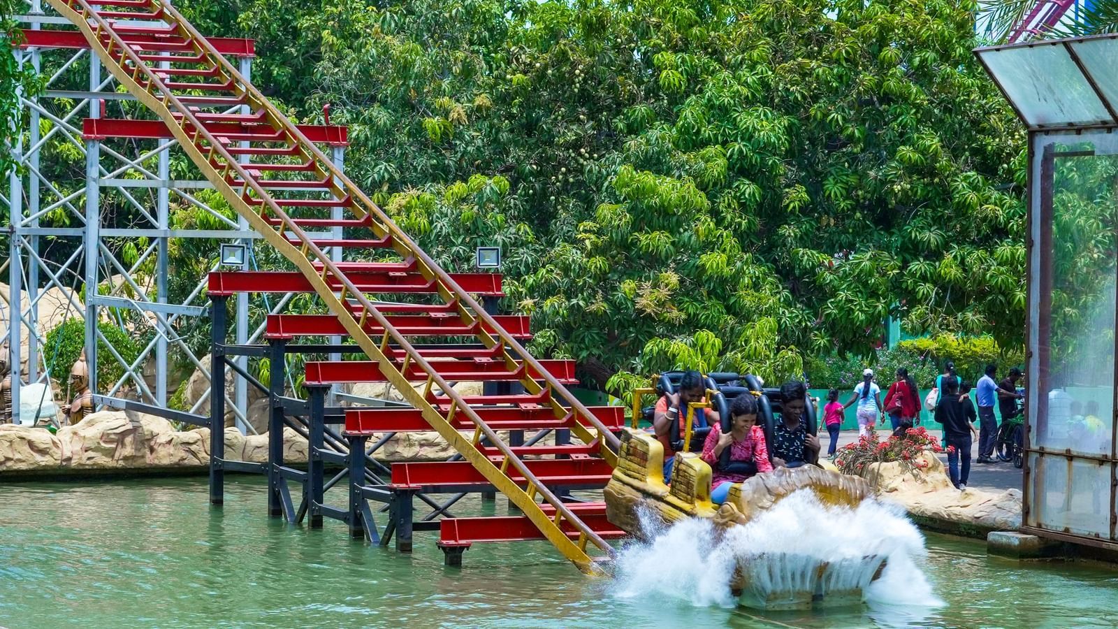 Roller Coaster ride that begins with people sitting in a ride which runs through the iron blocks and stairs leading down to the water with a splash at MGM Dizzee World.