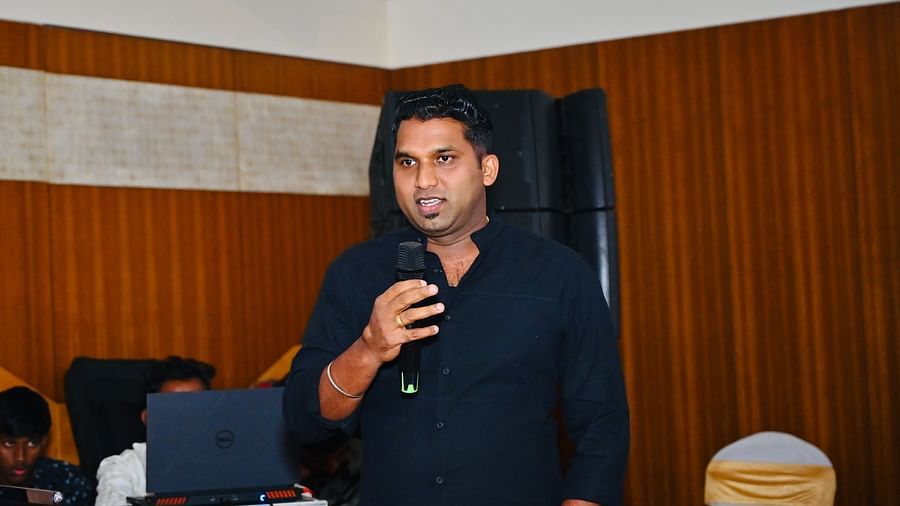 Image of a person holding mic and giving a speech