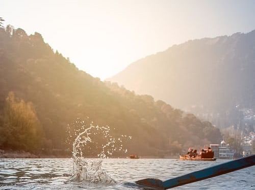 oar moving the boat in a mountain covered lake