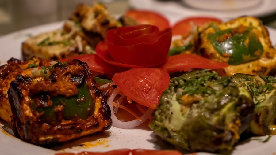 a plate of charred and marinated paneer served on a plate - Barsana Boutique Hotel Kolkata