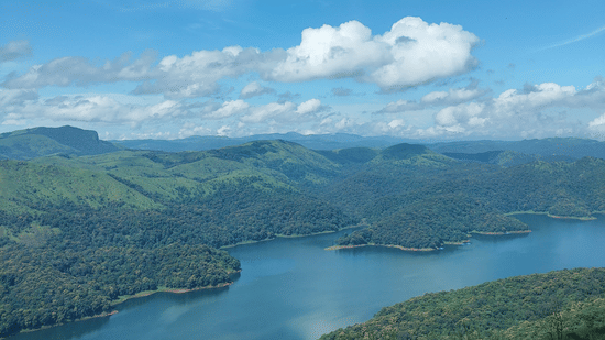 A high-angle view shows a winding blue river surrounded by green hills.