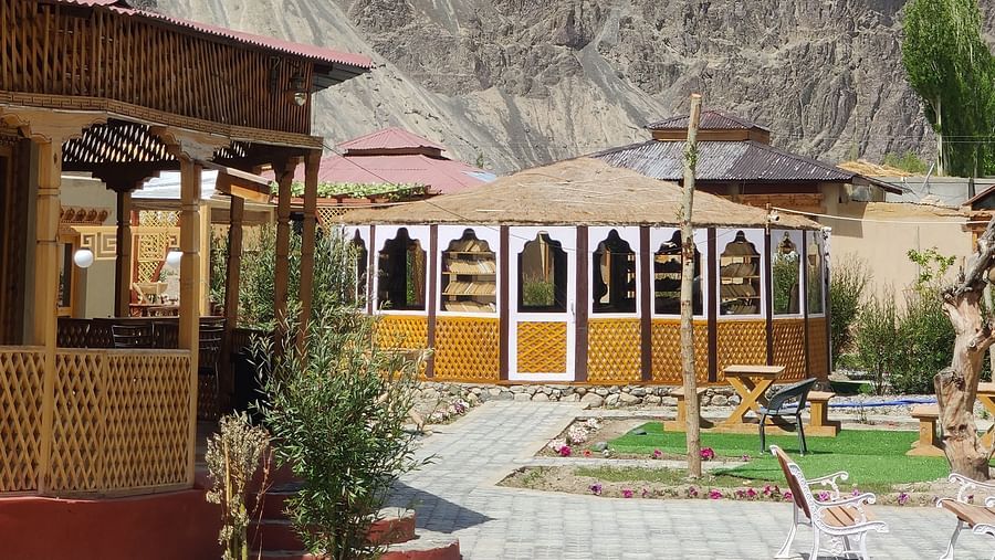 The exterior of White Sands Resort, Ladakh, showcasing the architecture and surrounding trees.