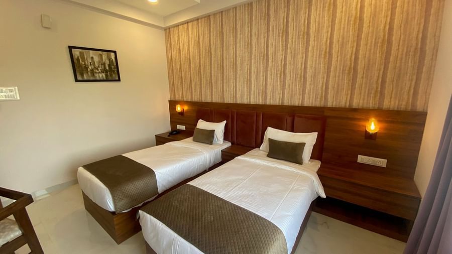 Side view of room with twin beds at Hotel Mumbai House, Indore