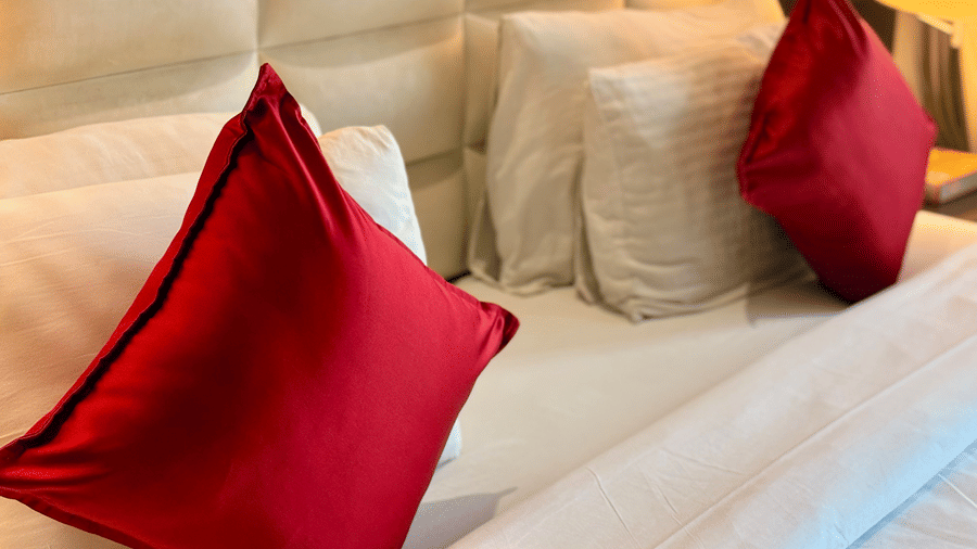 Close-up view of neatly arranged pillows and cushions on the King-size bed with upholstered headboard at the Executive Suite in Senses Hotel.