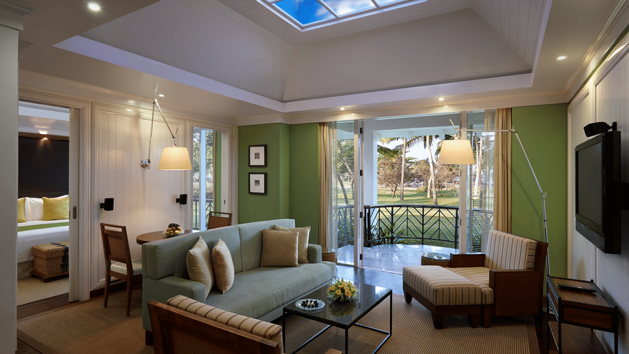 overview of the living room with sofas and a table inside Presidential villa - Caravela Beach Resort Goa