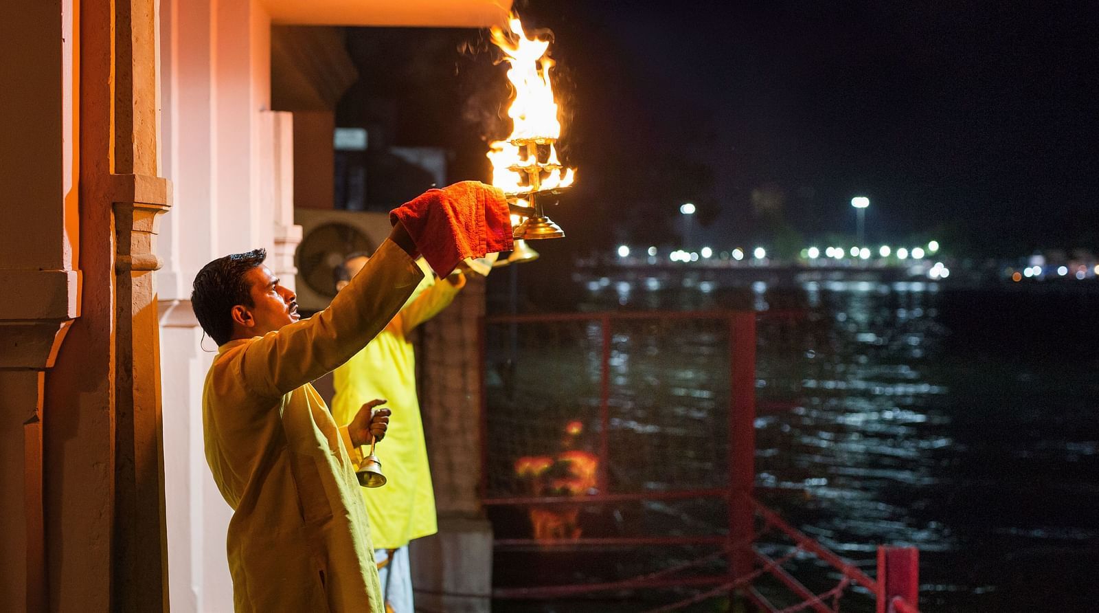 A picture of Evening Aarti performed by two people  -The Haveli Hari Ganga Haridwar