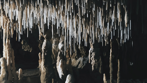 A close- up image of a cave with stalactites and stalagmites