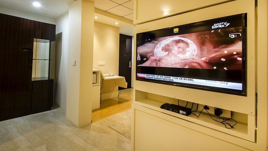 Suite with a television mounted on the wall at Art Boutique Hotel, Hyderabad
