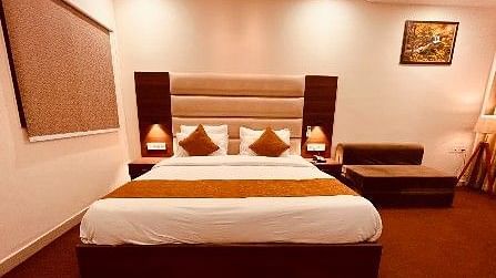 The executive room showcasing a bed, bedside tables, and a sofa cum bed - Five Elements Hotels, Haridwar