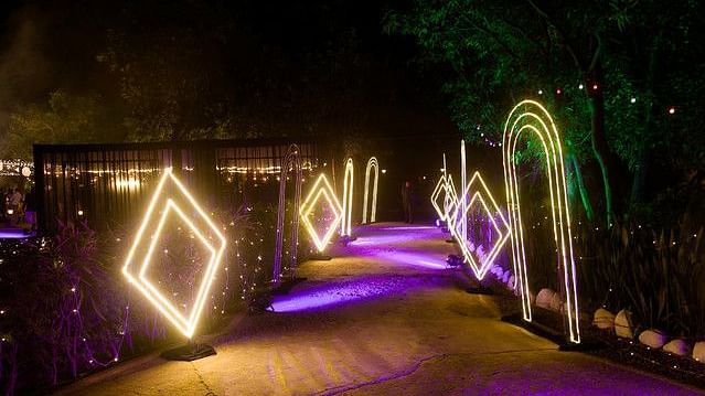 alt-text Lighted walkway with geometric frames and fairy lights.