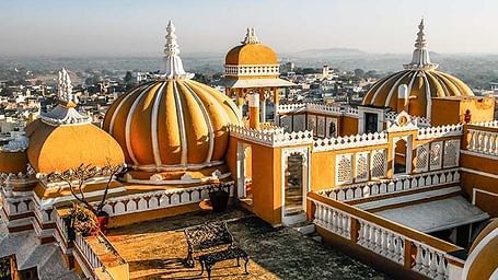 A image of the tombs of Deogarh Mahal during a sunset