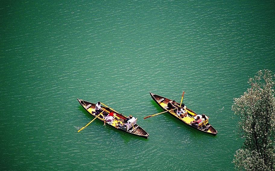 An image of two boats floating on a lake