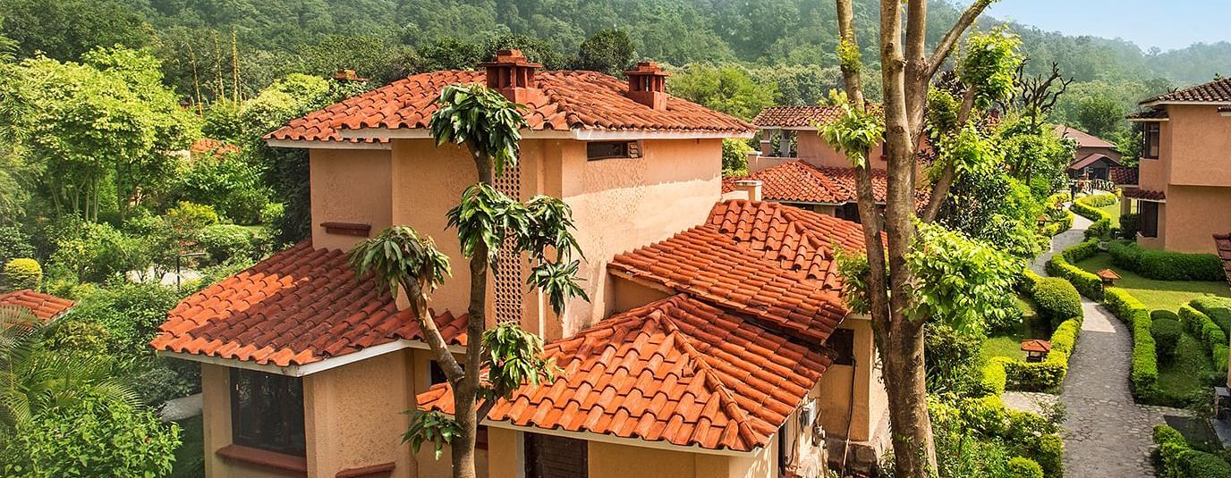An image of a villa with many rooms and cottages amidst the trees - The Riverview Retreat,  Corbett
