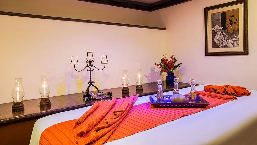 A spa table and candles beside it in a treatment room at our Spa in Nainital