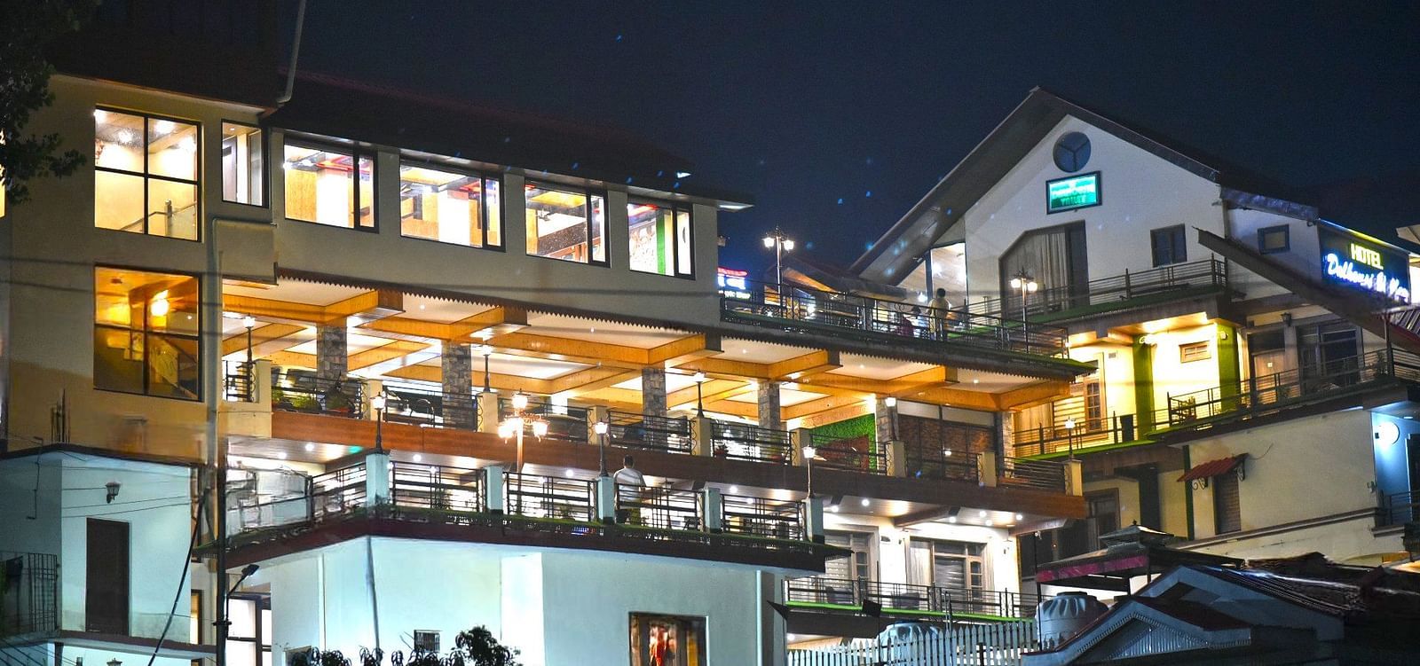 Facade image with warm lighting of DLS Dalhousie Valley Resort taken at night.