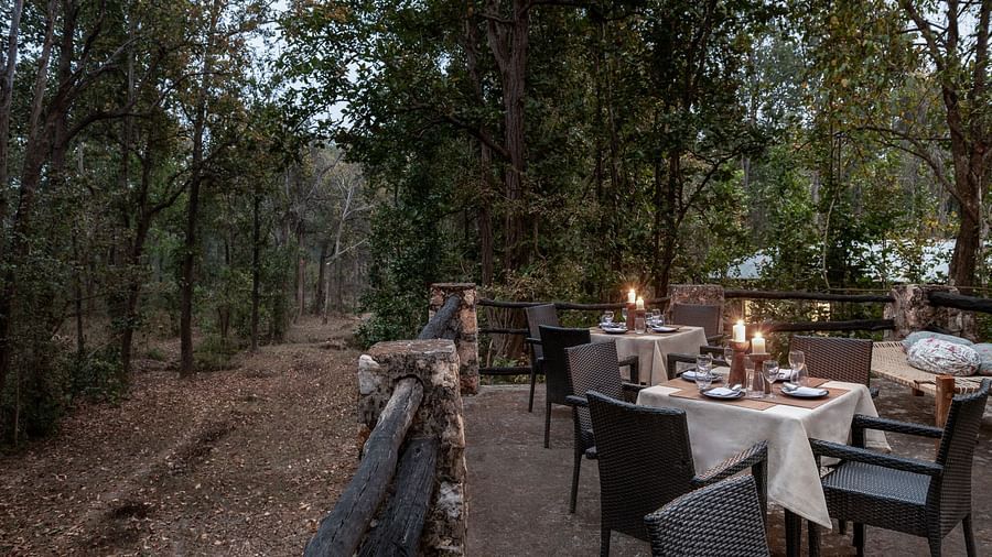 Dining setup at Machaan dining at Saccharum Safari Lodge, Balaghat