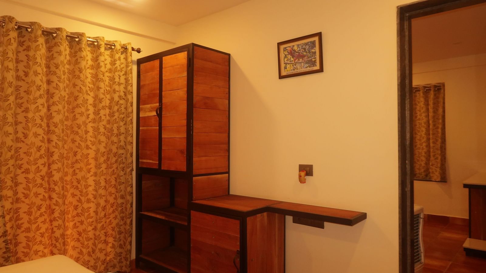 A view into one of the bedrooms at Forest Escape, showcasing a double bed and wooden storage units for guests' belongings.