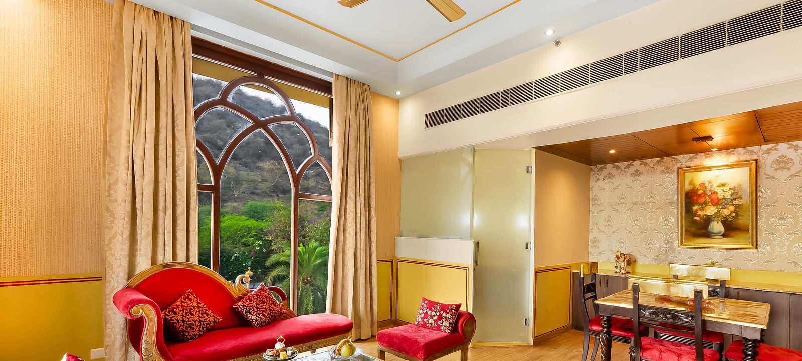 An overview of a living room with sofas, table and a dining table inside it - Rajasthali Resort & Spa, Jaipur.