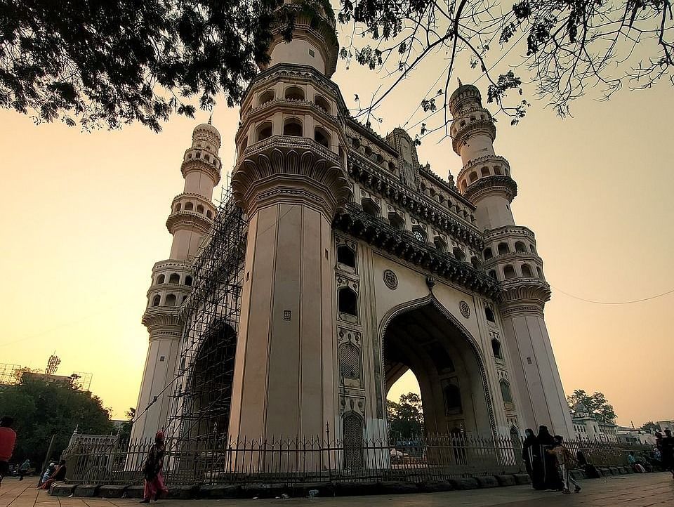 The iconic Charminar monument in Hyderabad, India, illuminated by the setting sun.