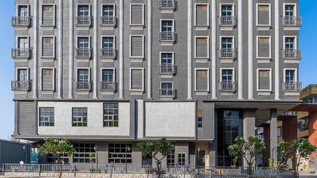 The facade view of a multi-storey hotel building with windows and entrance visible from the front at Perfectstayz Premium Udaipur By The Lake.