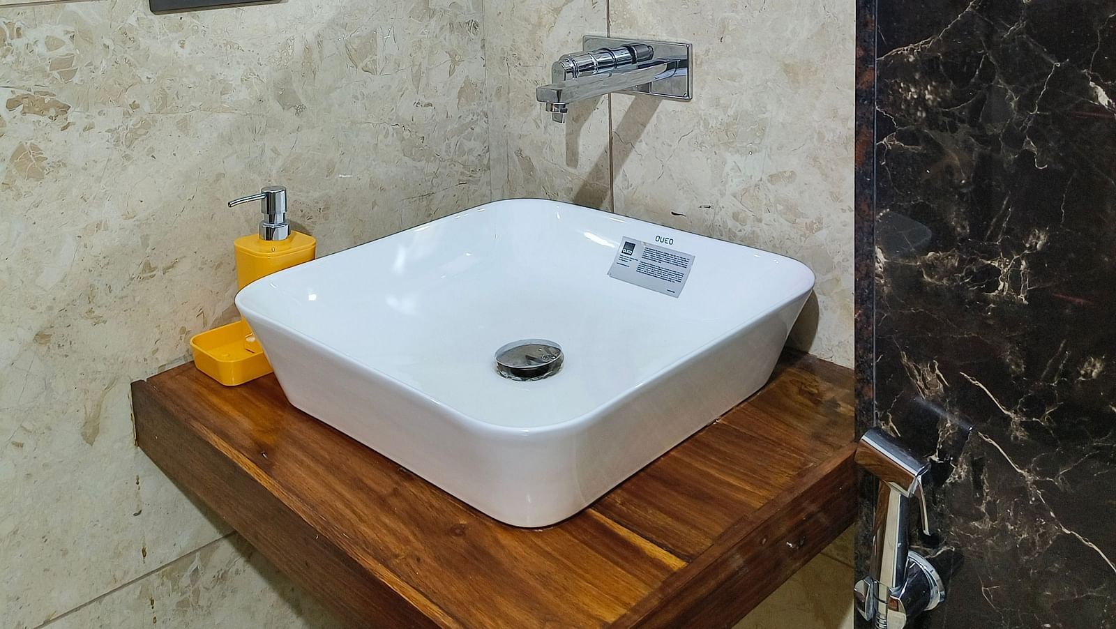 A sink with a mirror on the top of it in the washroom at 102 room at Ananda Holiday Home, Wayanad 2