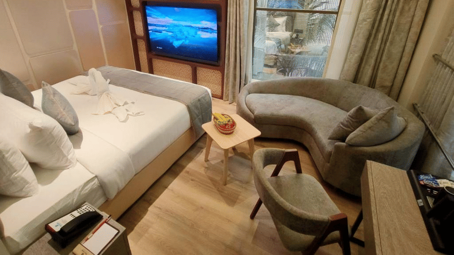 Suit Rooms with a comfy bed and a flat screen TV, a comfortable sofa , table and chair at Maxxvalue Hotel, MIDC