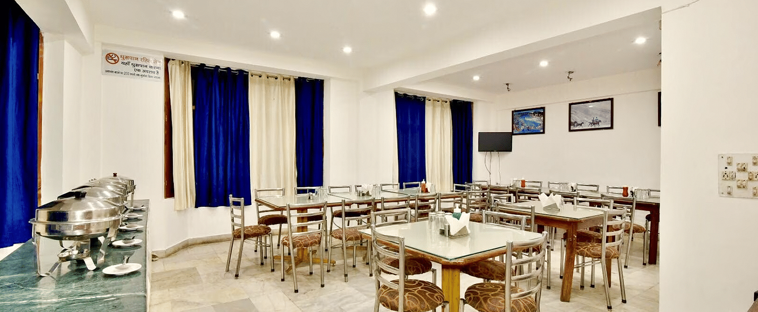 Well-lit interiors of the restaurant at DLS Hotel Devlok, Manali with the buffet arrangement towards the side