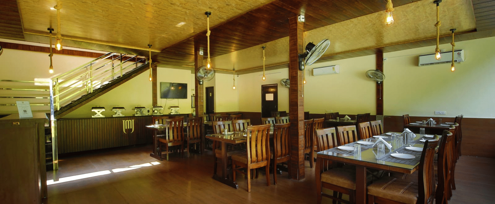 Dining area of the in-house restaurant at DLS MJ River Resort, Rishikesh.