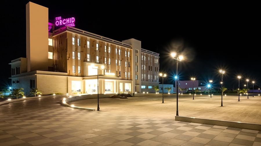 Facade image of The Orchid Hotel, Jamnagar in the night with the lights on 